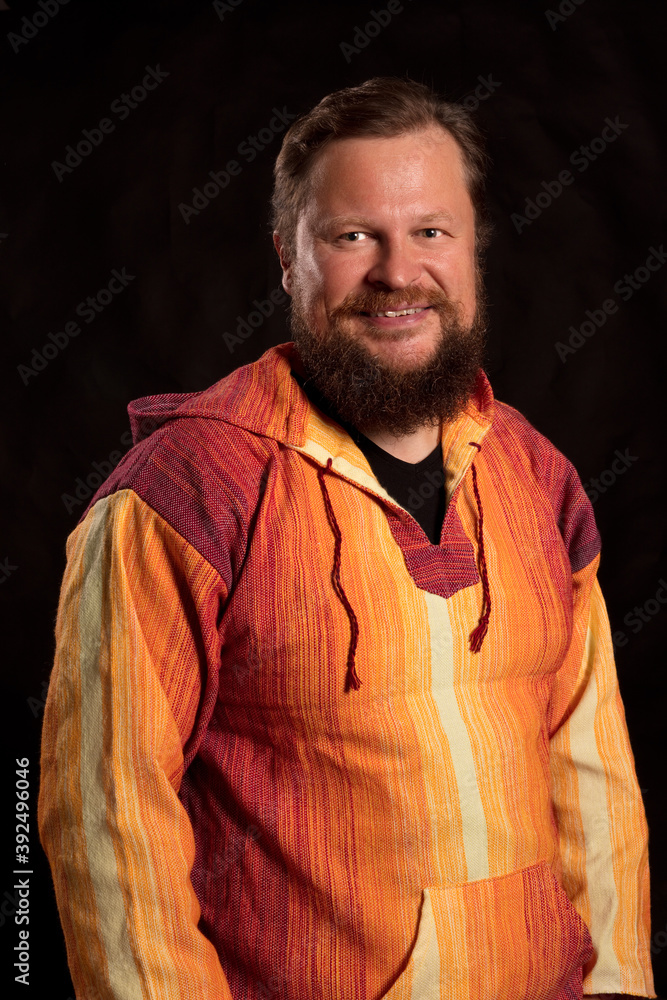 Solid bearded man in bright orange clothe smiling Solid bearded man in bright orange clothe smiling