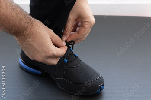 young man tying sneaker laces