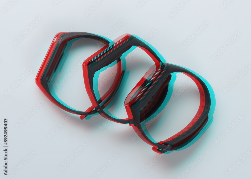 Glitch effect. Three smart bracelets on a white background. Modern gadgets for sports and everyday activities Glitch effect. Three smart bracelets on a white background. Modern gadgets for sports and everyday activities