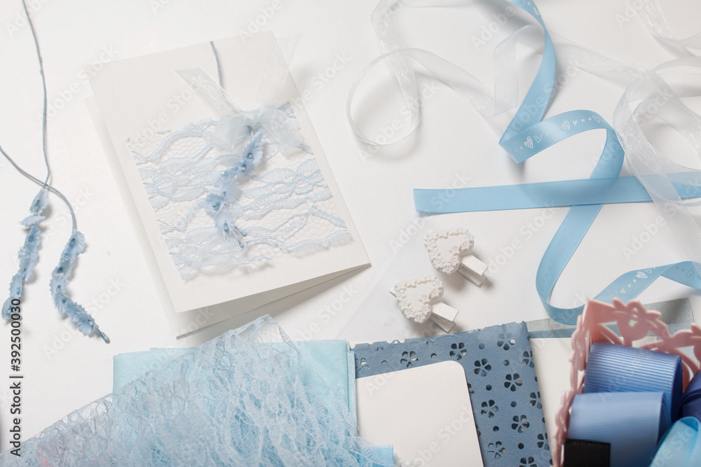 Making greeting cards. Handicraft accessories on the white surface of the table. Dried flowers and ribbons for crafts. Tools for creativity. Making greeting cards. Handicraft accessories on the white surface of the table. Dried flowers and ribbons for crafts. Tools for creativity.