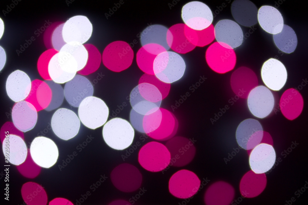 A blur of colored lights. Burning garlands on a dark background.