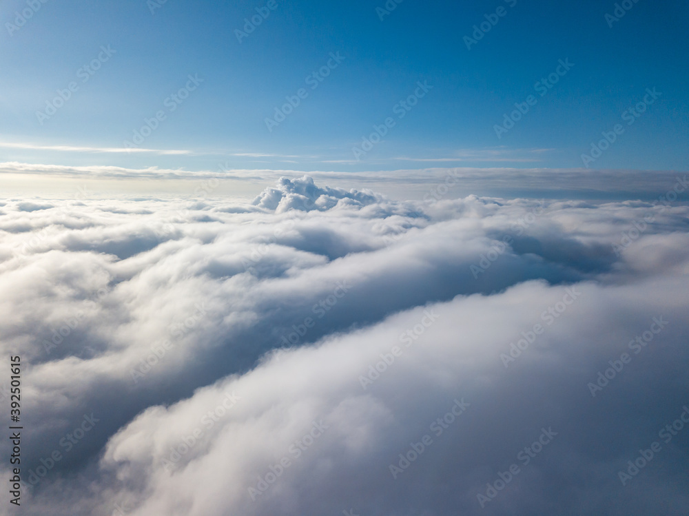 Aerial view. Flying over white clouds during the day in sunny weather. Aerial view. Flying over white clouds during the day in sunny weather.