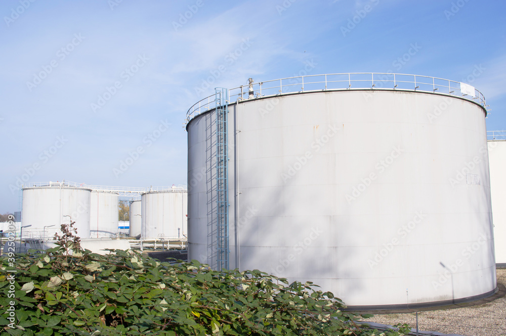 Large grey industrial tanks for petrol and oil storage in Arnhem, Netherlands