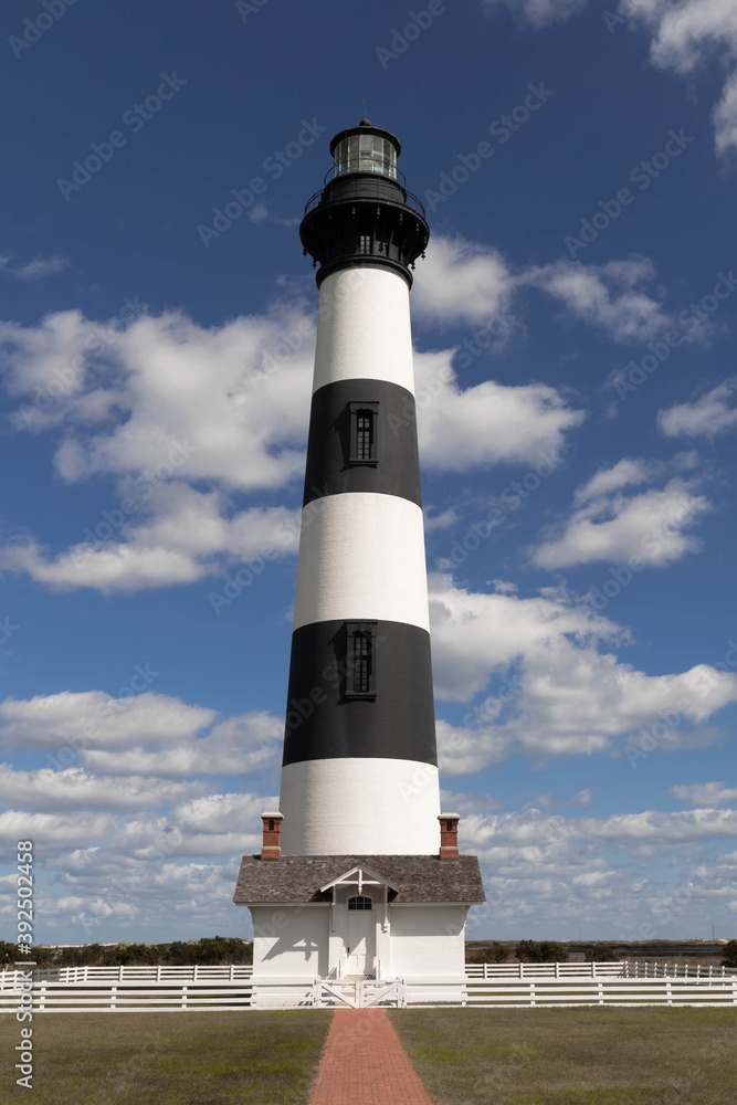 Bodie Island Lighthouse near Nags Head, NC in the Outer Banks of North Carolina with beautiful blue sky and soft white clouds in background. Hatteras National Seashore.