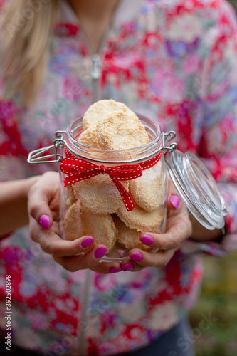 girl holding coconut cookies in the jar