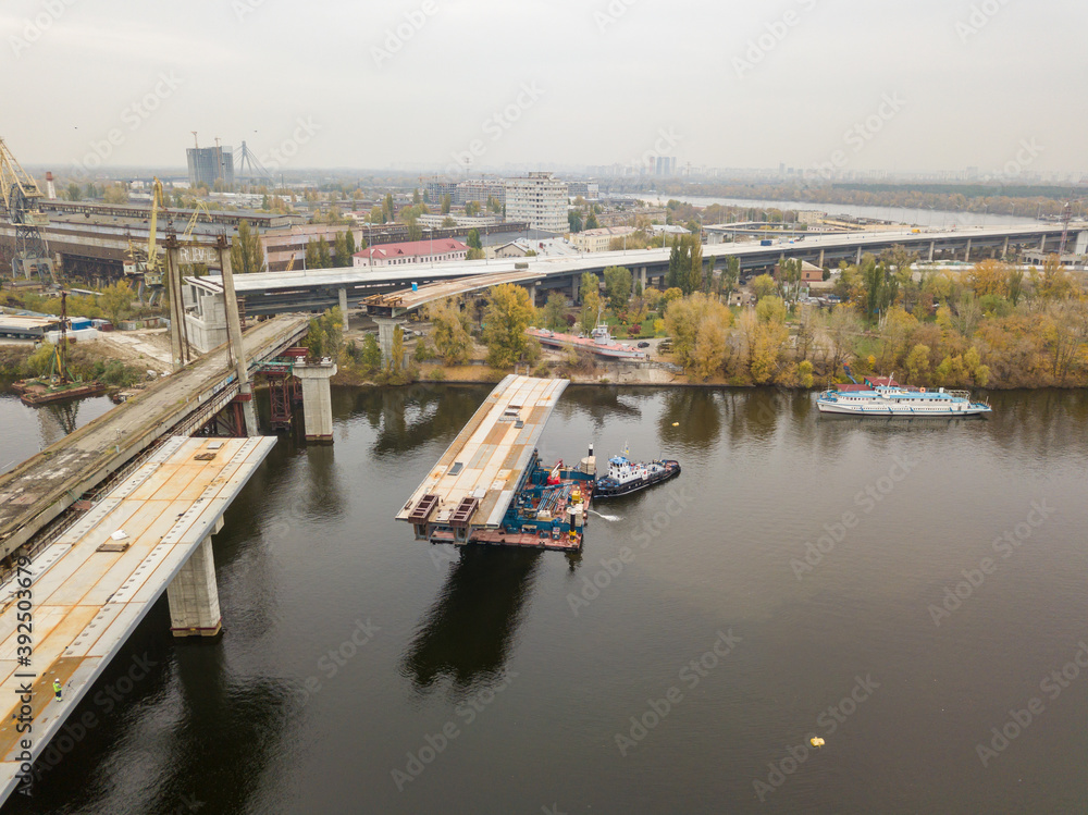 Aerial drone view. Bridge construction site in Kiev. Cloudy autumn morning.