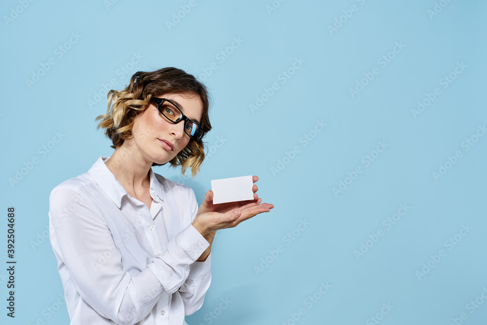 Woman wearing business card glasses in hands on blue background Copy Space cropped view Woman wearing business card glasses in hands on blue background Copy Space cropped view