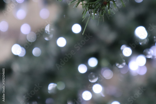 Christmas decorations - multicolored garlands. Selective soft focus. Snowflake from New Year's lanterns. © Zhanna