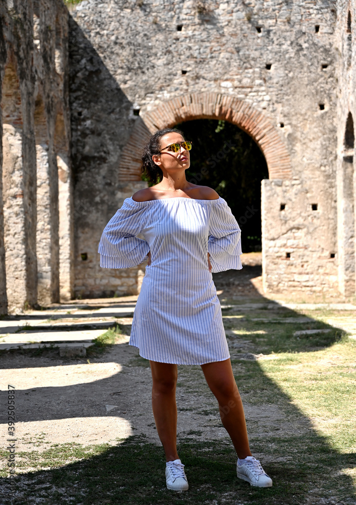 Young girl exploring an ruins of ancient city of Butrint.