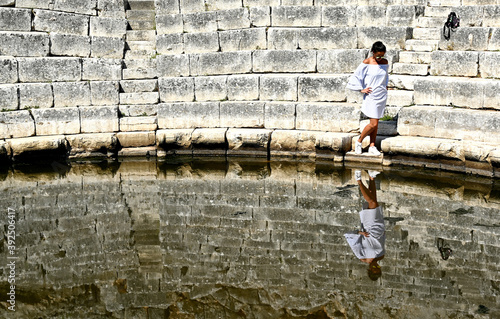 Young girl exploring an ruins of ancient city of Butrint.
