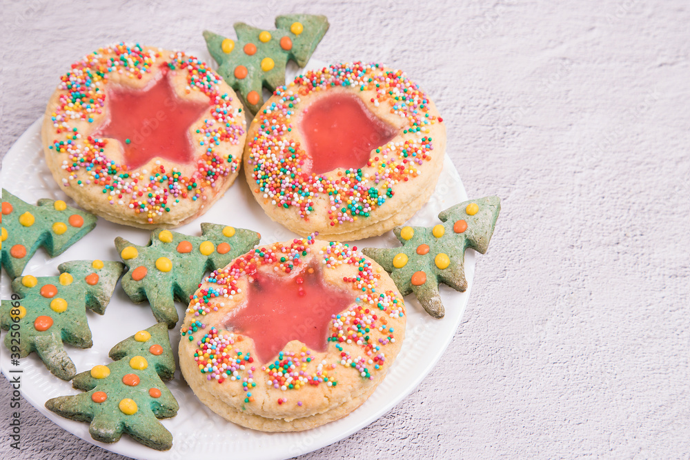 Christmas cookies on a white plate, light background. Close-up, copy space Christmas cookies on a white plate, light background. Close-up, copy space