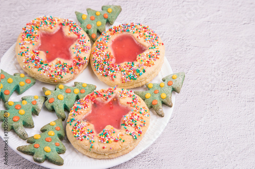 Christmas cookies on a white plate, light background. Close-up, copy space