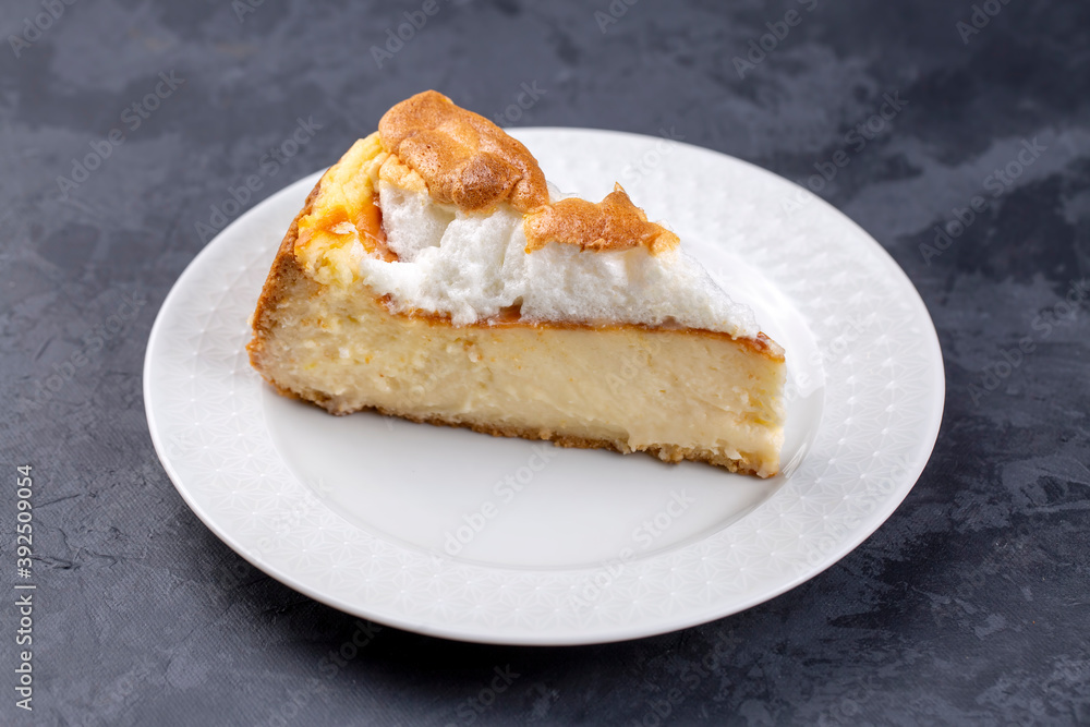 Homemade german cheesecake on beautiful plate on white table. Homemade german cheesecake on beautiful plate on white table.
