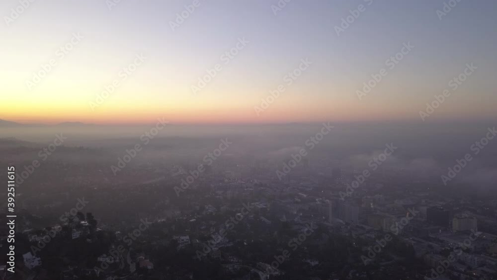 Fog and Clouds over Hollywood Hills at Sunrise with view above Los Angeles, California, Aerial Wide Angle tilt down Shot Fog and Clouds over Hollywood Hills at Sunrise with view above Los Angeles, California, Aerial Wide Angle tilt down Shot