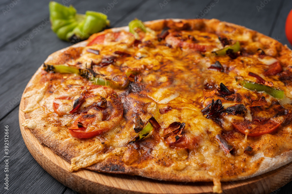 Vegetarian hot chili pizza on a wooden Board, close-up Vegetarian hot chili pizza on a wooden Board, close-up