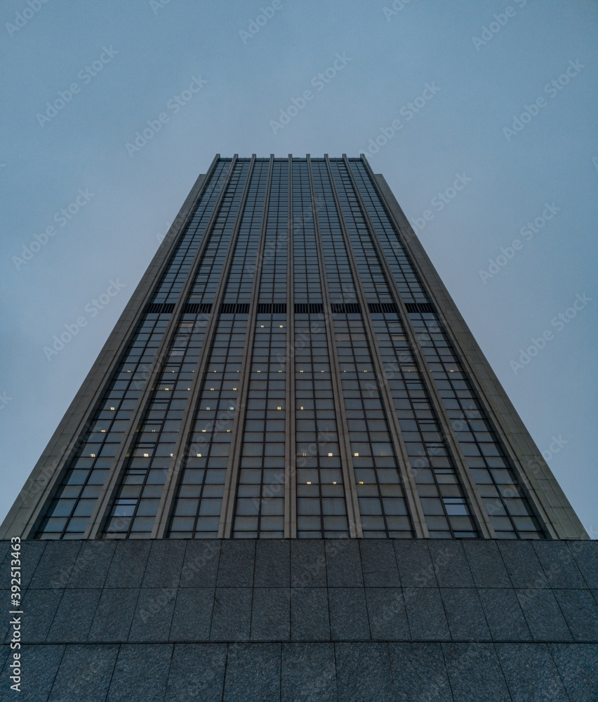 Upward view to high skyscraper full of offices Upward view to high skyscraper full of offices
