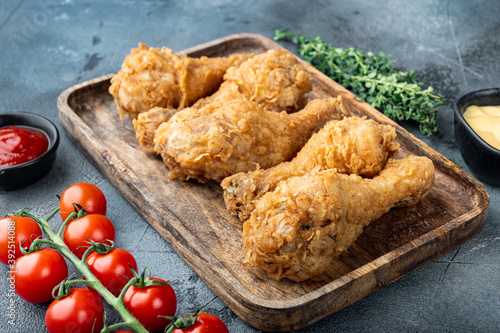Fried crispy chicken legs, drumstick  on grey background