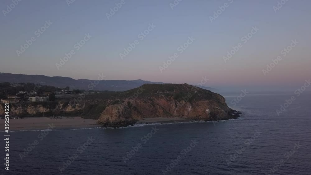 AERIAL: flight over Malibu, California view of beach Shore Line Pacific ocean at sunset with mountain cliff AERIAL: flight over Malibu, California view of beach Shore Line Pacific ocean at sunset with mountain cliff