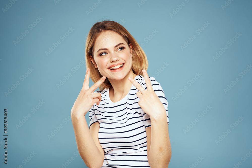 Pretty woman striped t-shirt fun emotions lifestyle blue background Pretty woman striped t-shirt fun emotions lifestyle blue background