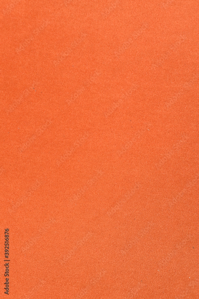 On a vertical orange fabric background, a frame made of live fluffy pine branches. On a vertical orange fabric background, a frame made of live fluffy pine branches.