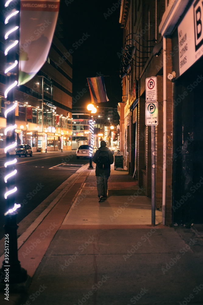 man walking down the street in the night
