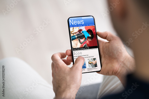 Man Using Smartphone Reading Electronic News