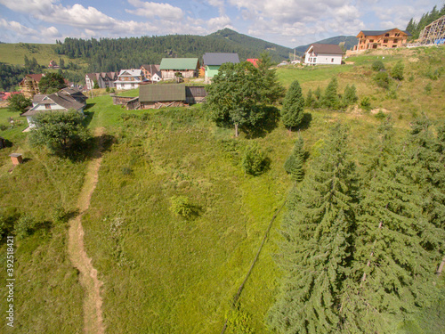 Village near deep Green Mountaines. Aerial View. photo