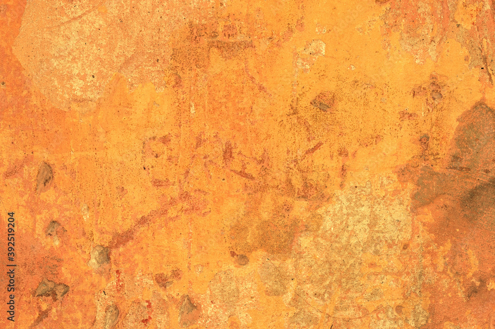 A large fragment of the orange clay wall of the old house with cracks and roughness, exfoliating part of the plaster. Vintage background. Rough flushed texture. Space to copy text. A large fragment of the orange clay wall of the old house with cracks and roughness, exfoliating part of the plaster. Vintage background. Rough flushed texture. Space to copy text.