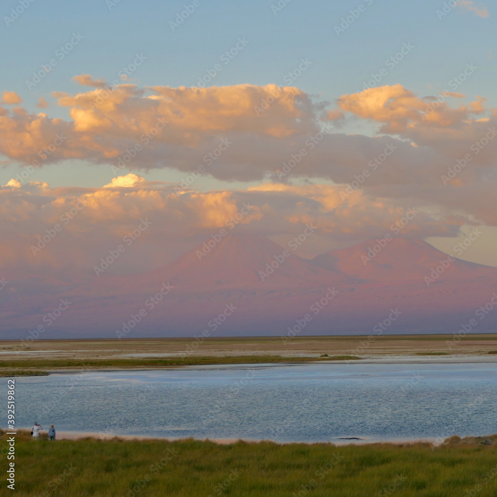 Sunset over salt lake in Atacama desert with orange mountains, Chile Sunset over salt lake in Atacama desert with orange mountains, Chile