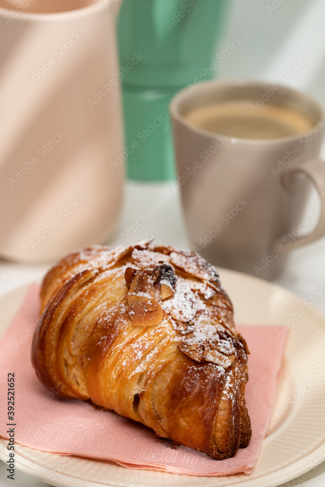 Homemade almond croissant and coffee