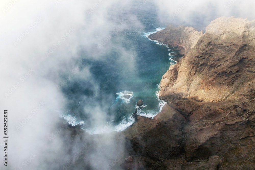 Fototapeta premium Flying over a scenic landscape, cliffs and ocean in a remote volcanic landscape of Tenerife, Canary Islands. High quality photography.
