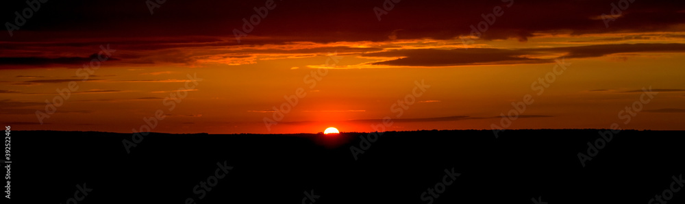 The sky and clouds are illuminated by the setting sun. Panorama. The sky and clouds are illuminated by the setting sun. Panorama.