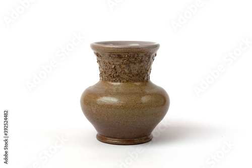 Small green clay vase on a white background