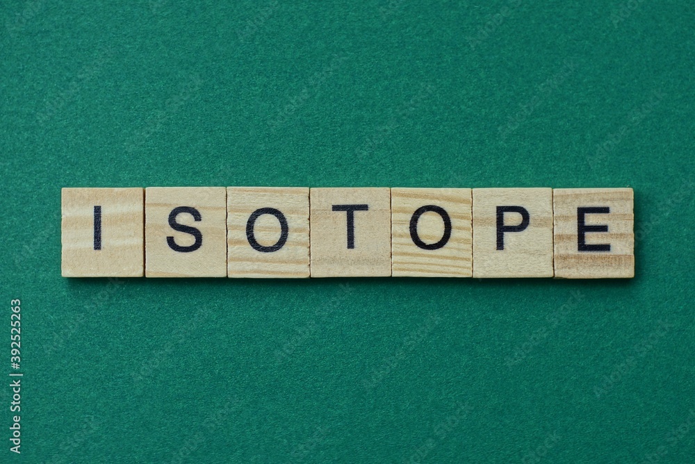 Ταπετσαρία gray word isotope made of wooden square letters on green background