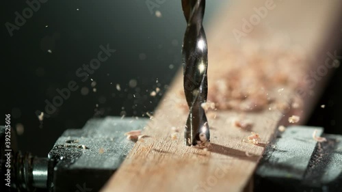 Super slow motion of detail of a drill bit drilling into wood. Filmed on high speed cinema camera, 1000 fps. photo