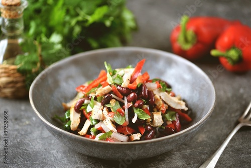 Salad with chicken breast, red beans, bell peppers, onions, walnuts and cilantro.
