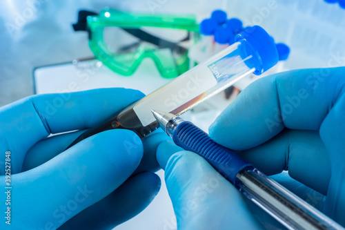 Man signs a test tube with ...