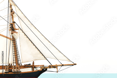 The bow of a model of a sailing ship with triangular sails and bowsprit