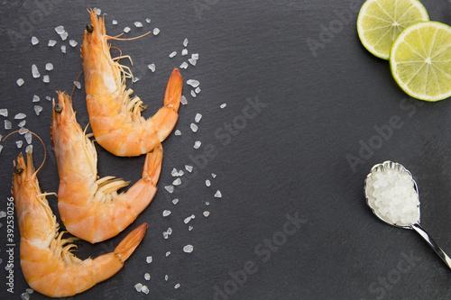 shrimp on a plate with lime and a spoonful of sali