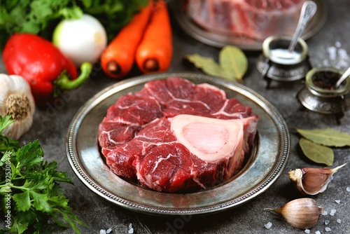 Raw beef shank with vegetables and garlic.
