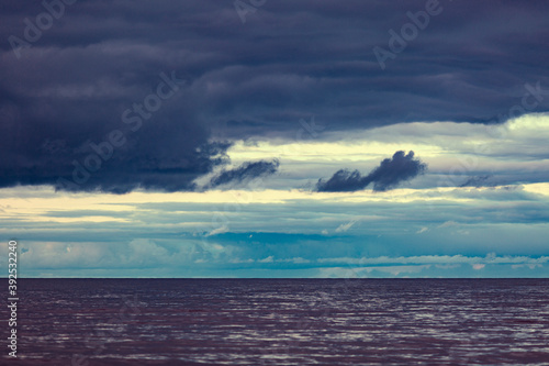 Fototapeta Naklejka Na Ścianę i Meble -  Dramatic clouds against the background of dark water