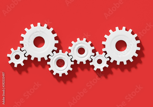 Many white connecting gear cogs of different sizes isolated on red background; flat lay, close up, top view, copy space; 3d rendering, 3d illustration