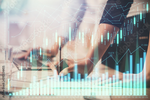 Multi exposure of woman hands typing on computer and financial chart hologram drawing. Stock market analysis concept. © peshkova