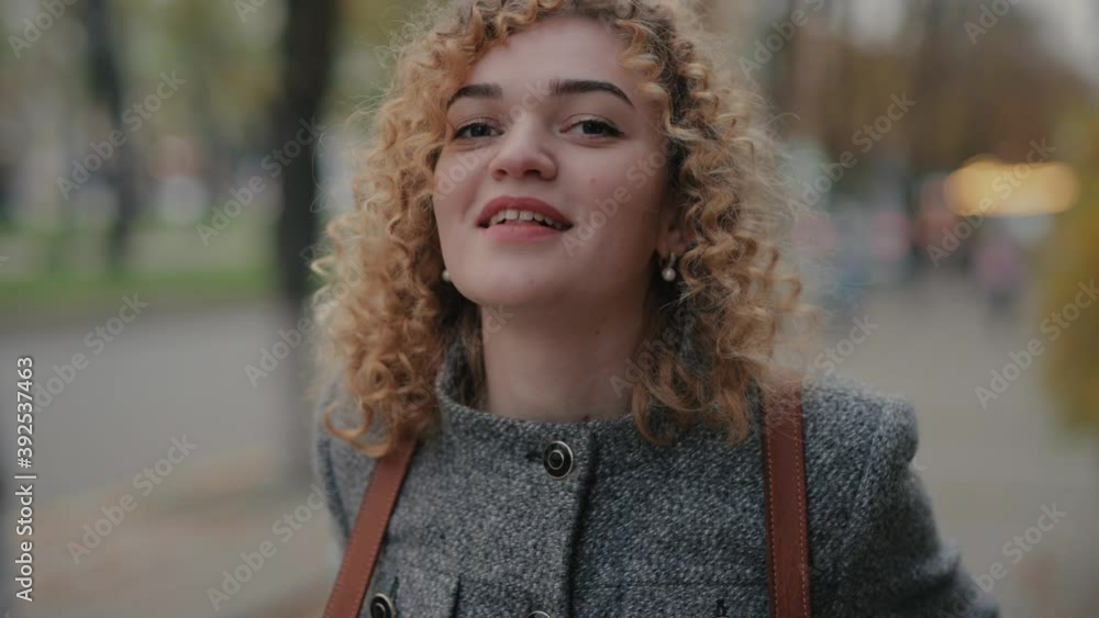Happy curly woman smiling funny at camera Happy curly woman smiling funny at camera