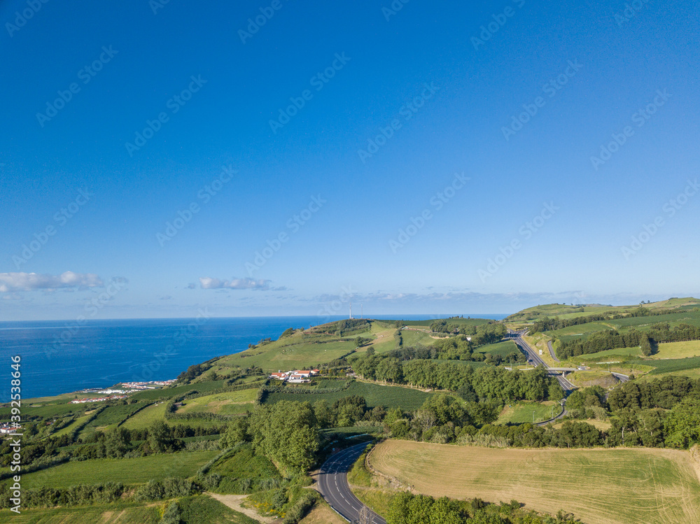 Fototapeta premium Aerial top view landscape in the North Coast of São Miguel Island. Road path background. São Miguel Island, Azores