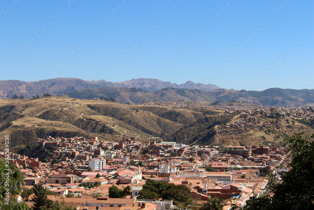 panoramic view of red tile roofs and white walls buildings at sucre white city in bolivia