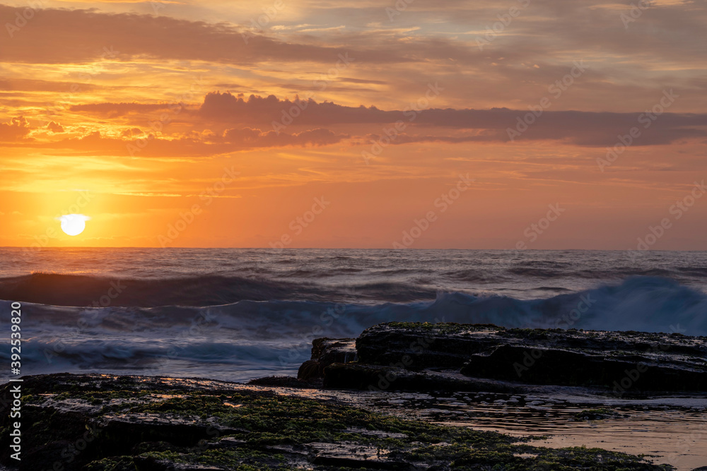 Sunrise over the sea on a beautiful morning at the beach Sunrise over the sea on a beautiful morning at the beach