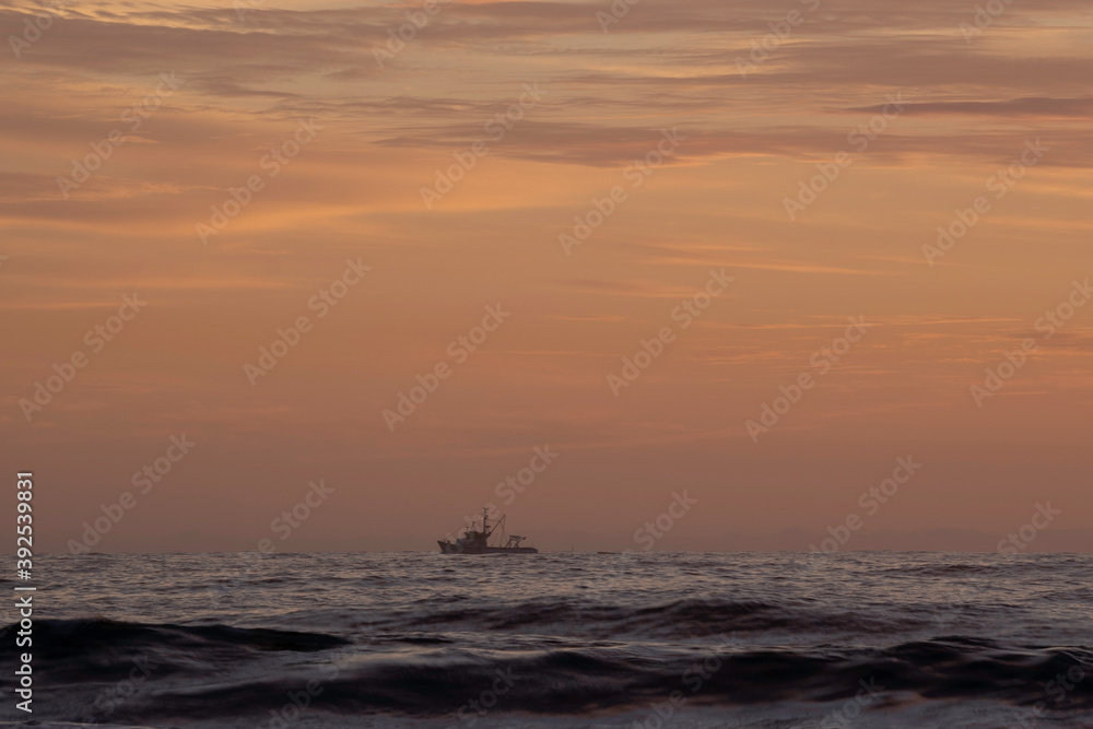 A boat on the hozizon at Sunrise at Turimetta Beach