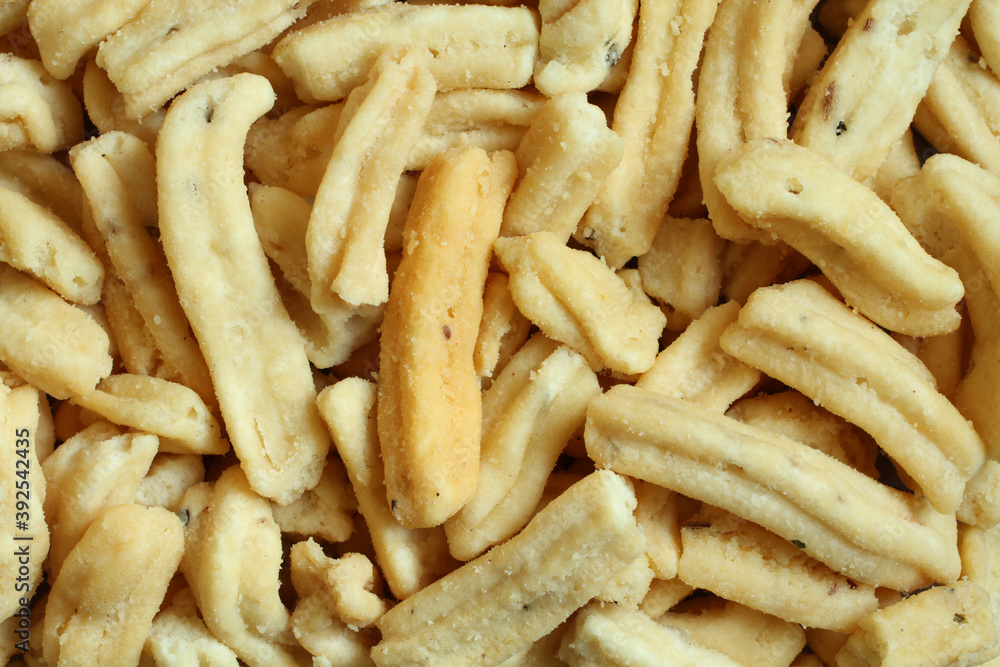 Ganthiya (Fried spicy chickpea flour sticks). View from above on sticks pile. Closeup Ganthiya (Fried spicy chickpea flour sticks). View from above on sticks pile. Closeup