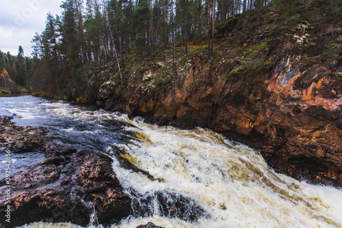 Autumn view of Oulanka National Park, landscape, a finnish national park in the Northern Ostrobothnia and Lapland regions of Finland,  wooden wilderness hut, cabin cottage, bridge, campground place photo